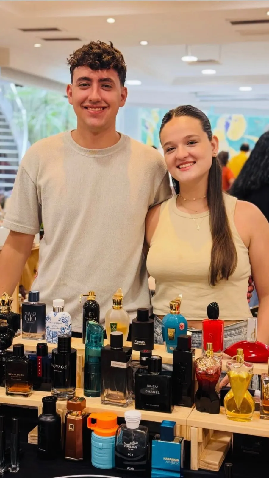 Santino y Martina detrás de su puesto de perfumes en una feria